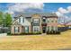 Charming two-story home with a manicured front lawn, brick facade and a inviting front entry at 4030 Amberhill Cir, Cumming, GA 30040