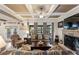 Inviting living room featuring coffered ceilings, stone fireplace and comfortable seating at 4030 Amberhill Cir, Cumming, GA 30040