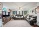 A living room featuring leather sofas, sports memorabilia, and neutral carpet at 4030 Amberhill Cir, Cumming, GA 30040