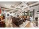 Open concept living area with coffered ceilings, hardwood floors and seamless flow into the kitchen at 4030 Amberhill Cir, Cumming, GA 30040