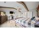 A large main bedroom features hardwood floors, neutral paint, ceiling fan, and bar area at 4030 Amberhill Cir, Cumming, GA 30040
