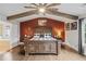 A spacious main bedroom features hardwood floors, neutral paint and a ceiling fan at 4030 Amberhill Cir, Cumming, GA 30040