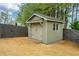 New shed in backyard with garage door and window is perfect for all of your storage needs at 4030 Amberhill Cir, Cumming, GA 30040