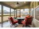 Screened in sunroom with seating area, outdoor furniture and ceiling fan at 4030 Amberhill Cir, Cumming, GA 30040