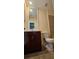 Bathroom features a cherry vanity with marble countertop and toilet at 5905 Brookside Oak Cir, Norcross, GA 30093