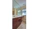 Bathroom featuring vanity with drawers, ample countertop, sink, and large mirror at 5905 Brookside Oak Cir, Norcross, GA 30093