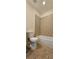 Neutral tiled bathroom with a standard bathtub and commode at 5905 Brookside Oak Cir, Norcross, GA 30093