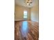 Cozy bedroom featuring hardwood floors, a ceiling fan, and a large window for ample natural light at 5905 Brookside Oak Cir, Norcross, GA 30093