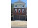Inviting townhome with a brick and siding exterior, complemented by a convenient two-car garage at 5905 Brookside Oak Cir, Norcross, GA 30093