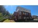 Three-story brick building showcasing balconies and multiple windows at 5905 Brookside Oak Cir, Norcross, GA 30093