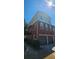 Beautiful three-story townhome featuring a brick facade, attached two-car garage, and manicured landscaping at 5905 Brookside Oak Cir, Norcross, GA 30093