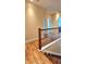 Hallway with wood staircase and dark railings at 5905 Brookside Oak Cir, Norcross, GA 30093