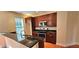 Well-lit kitchen features dark wood cabinets, stainless steel appliances and granite countertops at 5905 Brookside Oak Cir, Norcross, GA 30093