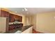 Open concept kitchen features stainless appliances, granite counters, and dark wood cabinets at 5905 Brookside Oak Cir, Norcross, GA 30093