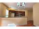 Bright kitchen featuring dark wood cabinets, stainless steel appliances, and bar with seating at 5905 Brookside Oak Cir, Norcross, GA 30093