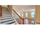 Open-concept living space with hardwood floors, a cozy fireplace, and stairs leading to the upper level at 5905 Brookside Oak Cir, Norcross, GA 30093