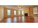 Spacious living room with hardwood floors, large windows, and a cozy fireplace at 5905 Brookside Oak Cir, Norcross, GA 30093