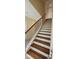 Carpeted staircase with wooden rails and white risers at 5905 Brookside Oak Cir, Norcross, GA 30093