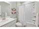 Clean, bright bathroom with white fixtures, shower-tub combo, and decorative shelves for a modern touch at 1165 Millennium Park Rd, Decatur, GA 30033