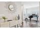 Elegant entryway with hardwood floors, stylish decor, and a glimpse into a bright, piano-filled room at 1165 Millennium Park Rd, Decatur, GA 30033