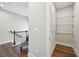 Hallway area with hardwood floors, view of coat closet and railing at 1165 Millennium Park Rd, Decatur, GA 30033