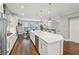 Open kitchen with a large center island, stainless steel appliances, and direct access to the dining area at 1165 Millennium Park Rd, Decatur, GA 30033