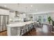 Modern kitchen with stainless steel appliances, large island, quartz countertops, and hardwood floors at 1165 Millennium Park Rd, Decatur, GA 30033