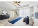 Relaxing primary bedroom boasts a tray ceiling, ceiling fan, and plush carpet at 1165 Millennium Park Rd, Decatur, GA 30033