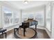 Elegant music room with a grand piano and natural light from surrounding windows at 1165 Millennium Park Rd, Decatur, GA 30033