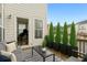 Inviting patio with outdoor seating, lush planters, and seamless indoor-outdoor flow to the home's interior at 1165 Millennium Park Rd, Decatur, GA 30033