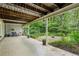 Covered patio area with outdoor seating and a view of the manicured backyard at 12 Braemore Dr, Atlanta, GA 30328