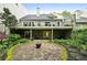 The backyard has a stone patio, covered space, and lush landscaping at 12 Braemore Dr, Atlanta, GA 30328