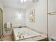 Bright bathroom featuring a large soaking tub with gold fixtures and a separate glass-enclosed shower at 12 Braemore Dr, Atlanta, GA 30328