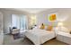 Bright bedroom with white bedding, stylish decor, and access to outdoor space at 12 Braemore Dr, Atlanta, GA 30328