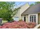 Traditional two-story home with attached garage, surrounded by beautiful landscaping and blooming bushes at 12 Braemore Dr, Atlanta, GA 30328