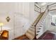 Spacious foyer with hardwood floors, a staircase, and plenty of natural light, exuding classic charm at 12 Braemore Dr, Atlanta, GA 30328