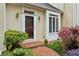 Inviting front entrance with brick walkway, well-manicured landscaping, and charming exterior lights at 12 Braemore Dr, Atlanta, GA 30328