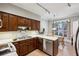 Functional kitchen with wood cabinetry, white countertops, and an adjacent dining area at 12 Braemore Dr, Atlanta, GA 30328