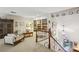 Open loft area with built-in bookshelves, comfortable seating, and a view of the staircase and entryway at 12 Braemore Dr, Atlanta, GA 30328