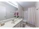Bright bathroom features a vanity with a large mirror and a shower and tub combination at 1501 Wynnes Ridge Cir, Marietta, GA 30067