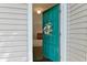A charming teal front door with floral wreath, inviting you into a freshly renovated condo at 1501 Wynnes Ridge Cir, Marietta, GA 30067