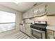 Functional kitchen featuring stainless steel appliances, white cabinets, and a bright window at 1501 Wynnes Ridge Cir, Marietta, GA 30067
