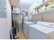 The laundry room is equipped with a washer, dryer and shelving for storage at 1501 Wynnes Ridge Cir, Marietta, GA 30067