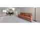 Open living space featuring neutral walls and flooring, contrasted by a brown leather sofa and black accents at 1501 Wynnes Ridge Cir, Marietta, GA 30067