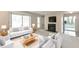 Bright living room featuring plush white sofas, a fireplace, and a large sliding glass door at 1501 Wynnes Ridge Cir, Marietta, GA 30067