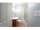 Bathroom features a vanity, toilet, tile floors, and a shower-tub combination with glass doors at 2020 Kenwood Se Pl, Smyrna, GA 30082