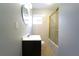 Bathroom features a dark wood vanity, toilet, tile floors, and a shower-tub combination with glass doors at 2020 Kenwood Se Pl, Smyrna, GA 30082