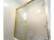 Bright bathroom featuring a shower with a gold frame and pink tiling at 2020 Kenwood Se Pl, Smyrna, GA 30082