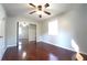 Bedroom with hardwood floors, closet with mirrored doors, ceiling fan, neutral color paint, and a window at 2020 Kenwood Se Pl, Smyrna, GA 30082