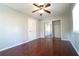 Bedroom with hardwood floors, a ceiling fan, closet with mirrored doors, and a window for natural light at 2020 Kenwood Se Pl, Smyrna, GA 30082